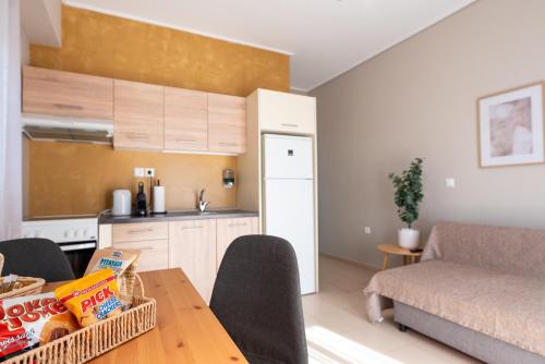a kitchen and a living room with a table at DreamCoast Apartments I in Artemida