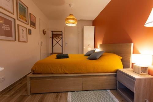 a bedroom with a yellow bed in a room at La Maisonnette - Disneyland Paris in Chanteloup-en-Brie