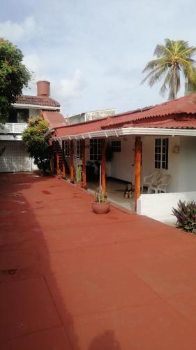 a house with a red driveway in front of it at Aptos Miss Ada in San Andrés