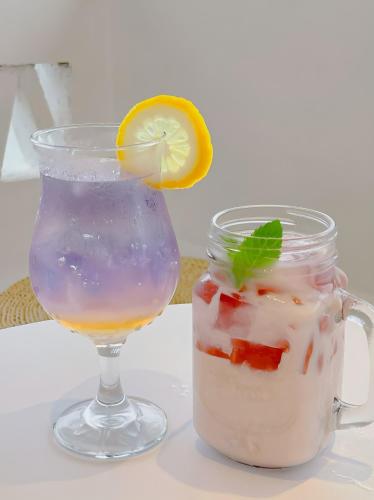 a drink in a mason jar next to a glass at Yangshuo KIRA Hotel - Moroccan Style in Yangshuo