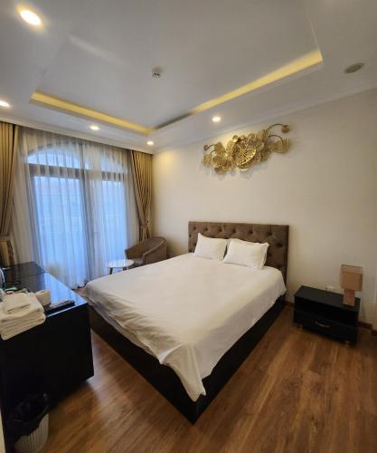 a bedroom with a large bed in a room at BREAKING DAWN- TAEYANG Hotel Phú Quốc in Phu Quoc