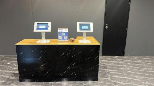 a table with two computer monitors on top of it at The Peak Tsutenkaku Elite in Osaka