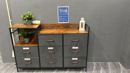 a black dresser with a wooden counter top at The Peak Tsutenkaku Elite in Osaka