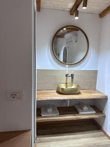 a bathroom with a sink and a mirror at Nashos Bungalows in (( Spile ))