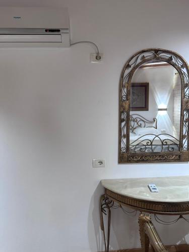 a bathroom with a mirror and a table with a sink at Nashos Bungalows in Spile