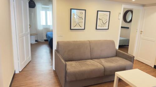 a living room with a couch and a table at La CASA del PORTO ANTICO in Genoa