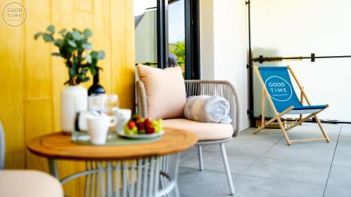 a living room with a table and a chair at Apartamenty Good Time - Belle View - Centrum in Szklarska Poręba