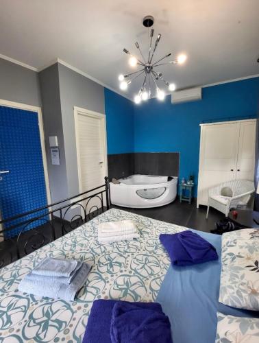 a bedroom with a bed and a bath tub and a ceiling at Villa Gaia - Luxury Villa, pool & wellness rooms in Bordighera