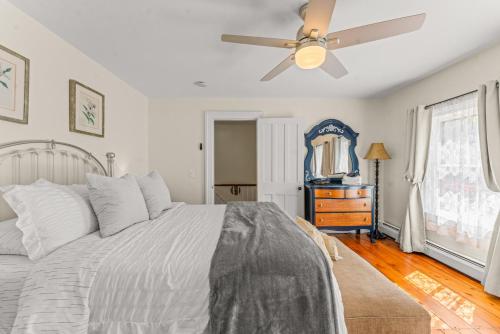 a bedroom with a bed and a ceiling fan at Charming 4BR Victorian Mystic Downtown in Groton