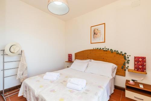a bedroom with a bed with two towels on it at Casa Isolotto D'Ogliastra - vista mare in Lotzorai