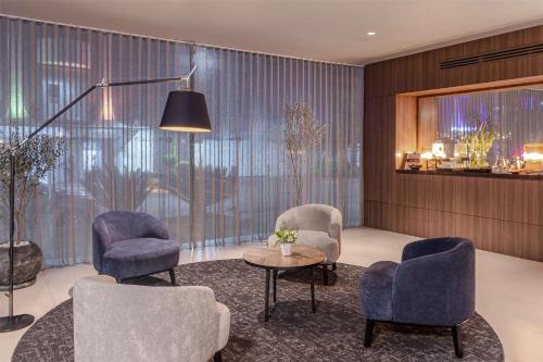 a living room with two chairs and a table at NH Collection Mexico City Reforma in Mexico City