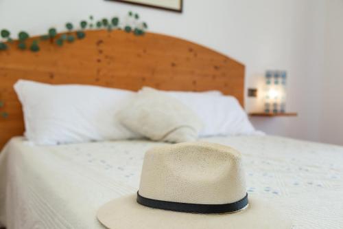 a hat is sitting on top of a bed at Casa Isolotto D'Ogliastra - vista mare in Lotzorai