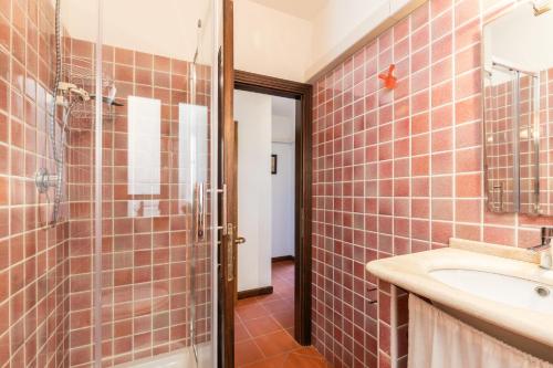 a bathroom with a sink and a shower at Casa Isolotto D'Ogliastra - vista mare in Lotzorai