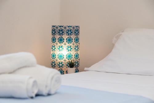 a room with two beds and a lamp with towels at Casa Isolotto D'Ogliastra - vista mare in Lotzorai