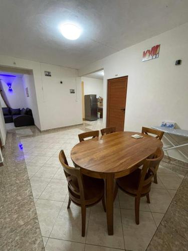 a wooden table and chairs in a living room at Rs villa 2 share apartment 100 mts to the beach and bus stop in Flic-en-Flac