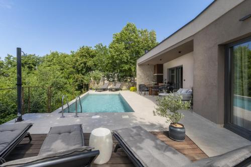 a backyard with a swimming pool and a house at Villa Veros for 5 people near Labin - Rabac with private pool & kids playground in Labin
