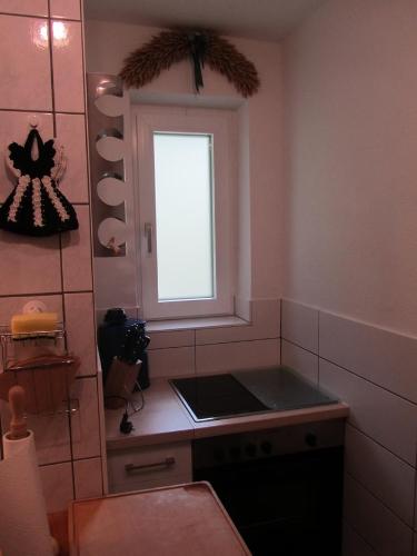 a small kitchen with a window and a stove at Haus Annelies Walchsee in Walchsee
