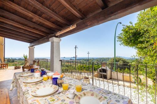a table with plates of food on top of a balcony at Casa Isolotto D'Ogliastra - vista mare in Lotzorai