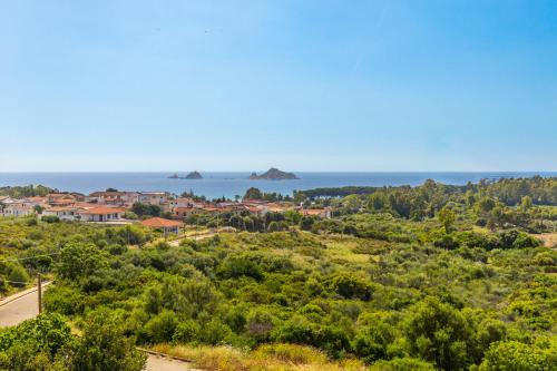 a view of a town with the ocean in the background at Casa Isolotto D'Ogliastra - vista mare in Lotzorai
