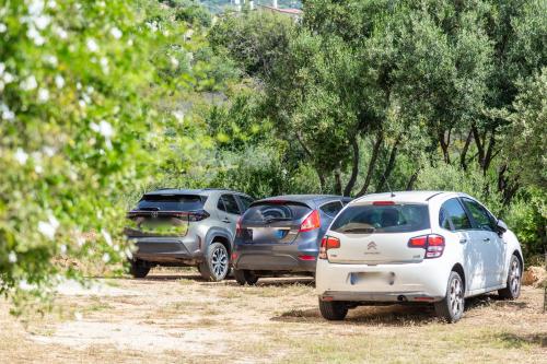 three cars parked next to each other on a dirt road at Casa Isolotto D'Ogliastra - vista mare in Lotzorai