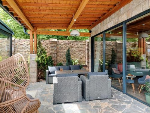 a patio with wicker chairs and a table at Vila MP Banstol 4*- Brdež do, Fruška gora in Inđija