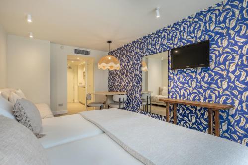 Posteľ alebo postele v izbe v ubytovaní Hoposa Pollensamar Apartamentos