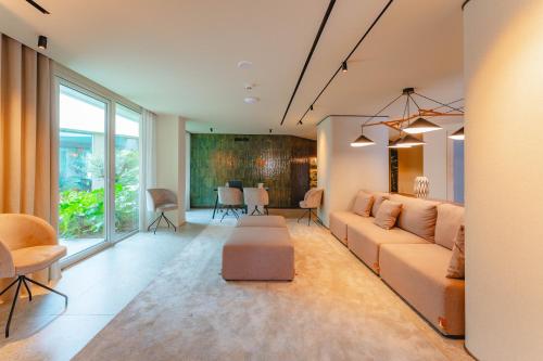 a living room with a couch and a table at Duas Torres Hotel in Funchal