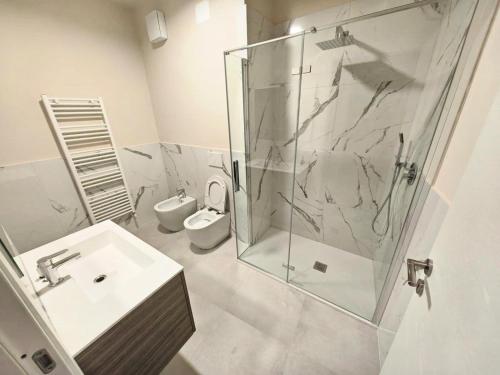 a bathroom with a shower and a sink and a toilet at MS Sea Port Rooms in Ancona