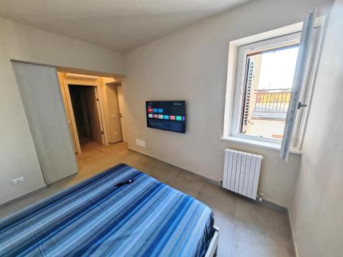a bedroom with a bed and a tv in it at MS Sea Port Rooms in Ancona