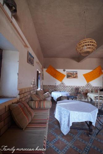 a living room with a couch and a table at Family Moroccan House in Merzouga