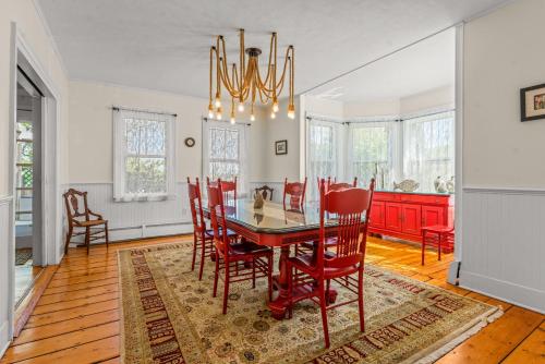 a dining room with a red table and chairs at Charming 4BR Victorian Mystic Downtown in Groton