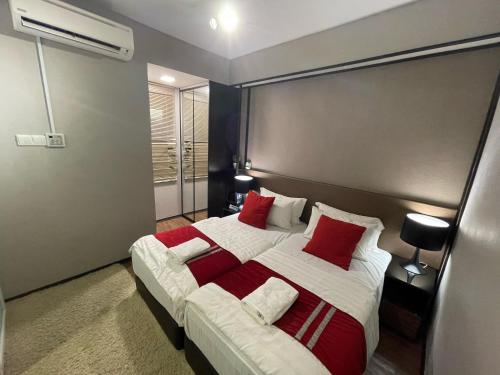 a bedroom with a large bed with red pillows at Amazing Seaview Duplex George Town Maritime Suites 20 in George Town