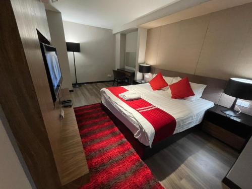 a hotel room with a bed and a red rug at Amazing Seaview Duplex George Town Maritime Suites 20 in George Town