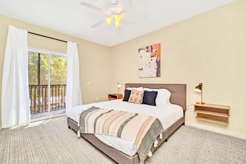 a bedroom with a large bed and a window at Near Disney - 2BR Condo Unit - Pool and Hot Tub in Orlando