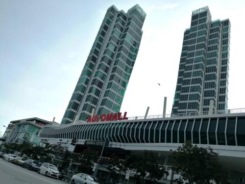 two tall buildings with cars parked in front of them at Amazing Seaview Duplex George Town Maritime Suites 20 in George Town