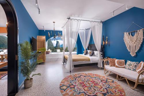 a bedroom with a bed and a blue wall at Yangshuo KIRA Hotel - Moroccan Style in Yangshuo