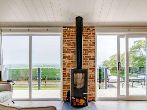 a fireplace in a living room with a brick wall at 2 Bed in St Andrews 83173 in Anstruther