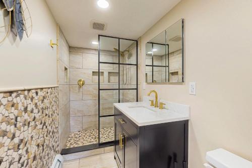 a bathroom with a sink and a shower at The Apartment at the Compound in Fort Ann
