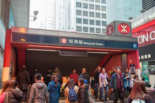 a crowd of people walking into a building at MK STAY - formerly HOTEL MK in Hong Kong