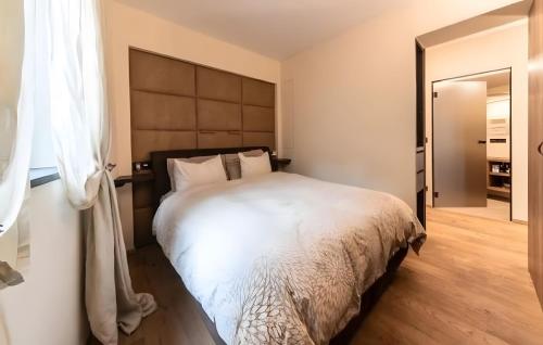 a bedroom with a large white bed in a room at Boutique Hotel Santer Klause in Merano