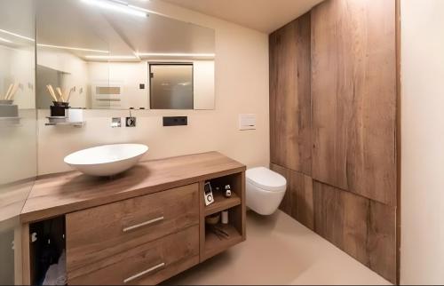 a bathroom with a sink and a toilet at Boutique Hotel Santer Klause in Merano