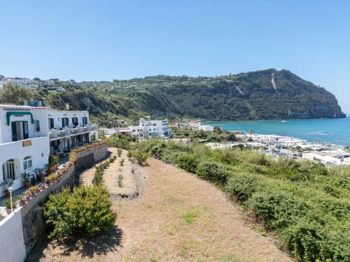 a view of the town of antiparos with the ocean at Appartamenti Casa del Sole in Ischia