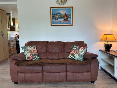 a brown leather couch sitting in a living room at Cottage 486 - Roundstone in Roundstone