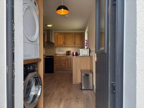 a kitchen with a washing machine and a washer at Cottage 486 - Roundstone in Roundstone