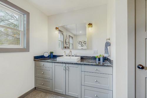 a bathroom with a sink and a mirror at The House at the Compound in Fort Ann