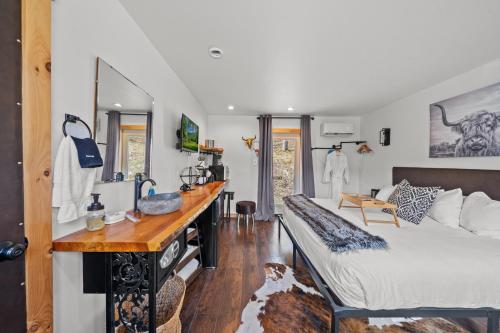 a bedroom with a bed and a desk in it at Green Acres Retreat in Hancock