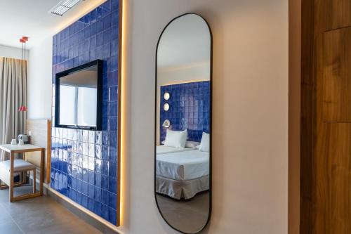 a mirror in a room with a bed at Perla Marina in Nerja
