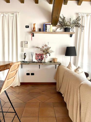 a bedroom with a bed and a table and a desk at Casa Frida, penthouse on the lake in Lonato del Garda