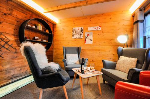 a room with chairs and a table and a mirror at Chalet La Scie in Morgins