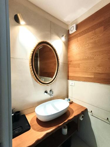 a bathroom with a white sink and a mirror at Sette Fate Suites & Spa in Palermo